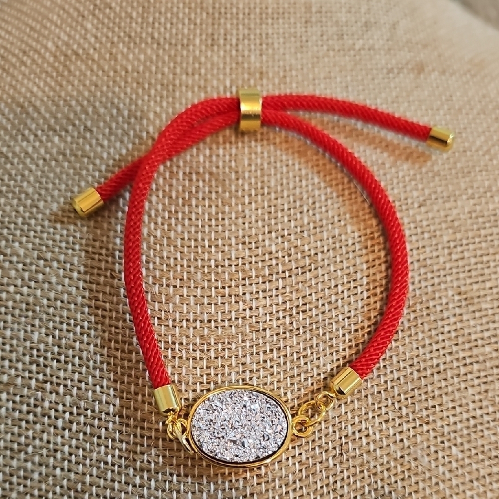 Silver Druzy Adjustable Bracelet With Gold Accents And Red Band.